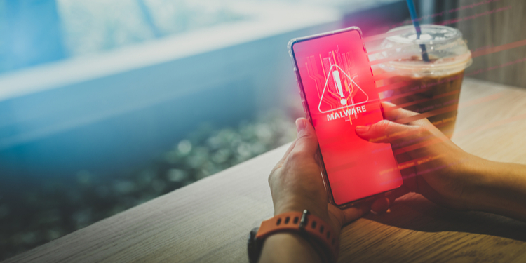 Close up hand of smartphone with malware warning